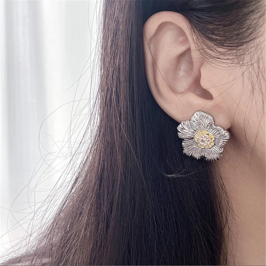 woman wearing gold-plated earrings in a romantic Valentine's setting
