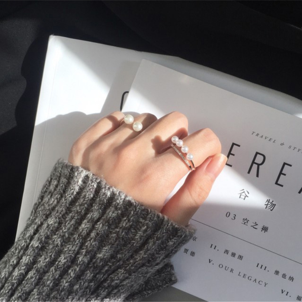 Hand measuring finger with a strip of paper to determine ring size at home