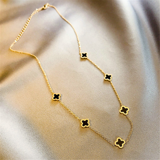 Woman wearing a thin gold chain choker necklace, close-up neckline shot