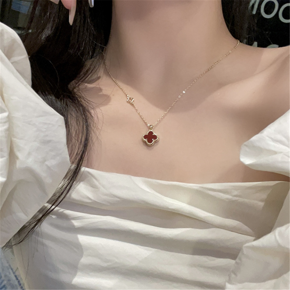 woman wearing a gold pendant necklace in a cozy Christmas setting