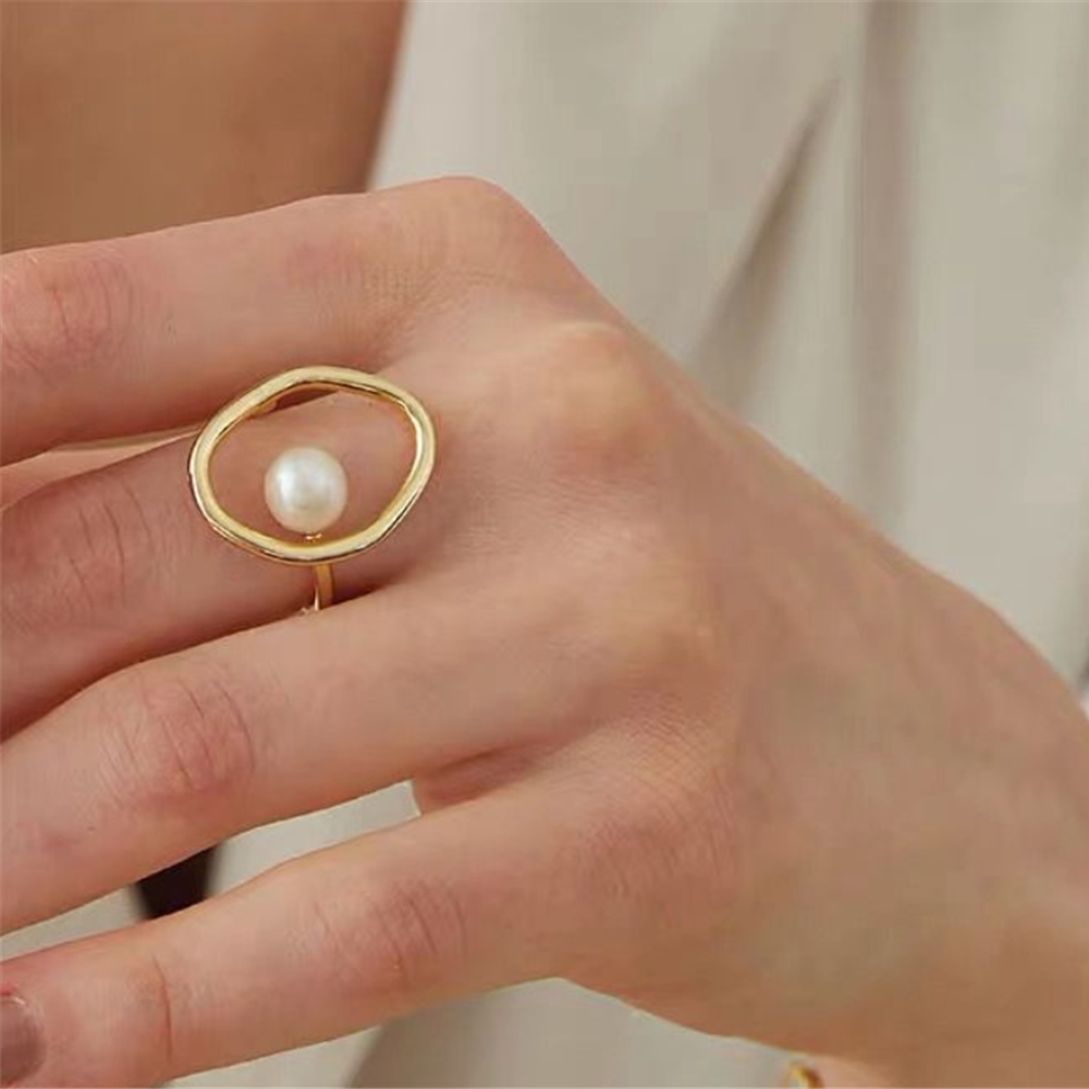 woman wearing a gold fashion ring in a festive Christmas setting
