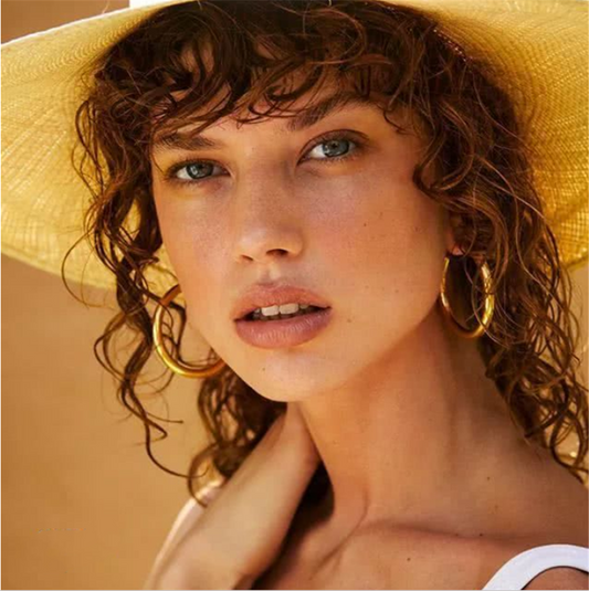 woman wearing a gold cocktail ring, everyday fashion styling